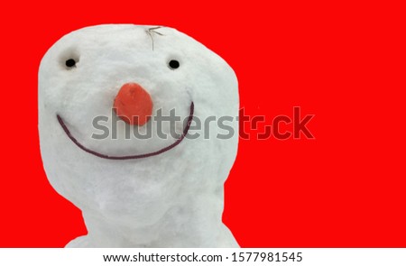 Smiling snowman on red background with naive face . Template for New Year card or poster.