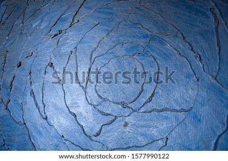 Modern art abstract pattern of crooked lines oil paints on a metallic blue background