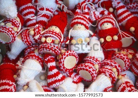 Little hand knitted dolls with woolen clothing to keep warm in winter, Christmas decorations