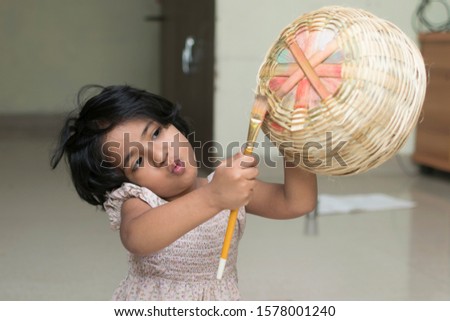 Cute little girl painting on bamboo casket. Indian little girl making painting. Creative child artist