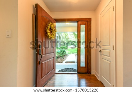 Open front door with wreath interior view Royalty-Free Stock Photo #1578013228