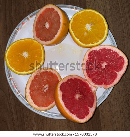 Oranges and Grapefruits cut in a plate