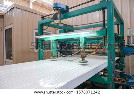 Press machine glutes panel. Plant for the production of sandwich panels from styrofoam Royalty-Free Stock Photo #1578071242