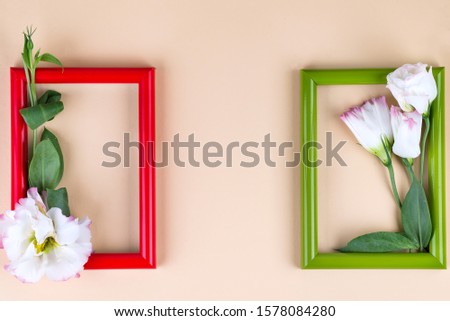 Two color frames with red hearts and flowers eustoma on beige paper background with copy space. Love concept