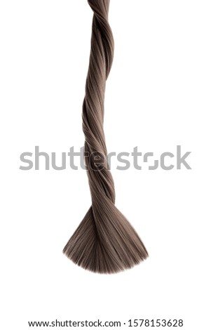 Brown twisted hair on white background, isolated. Looks like animal tail. Carefully trimmed tips