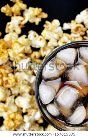 popcorn and cola on the black background