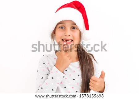 Cute little girl in the santa claus hat on a white background