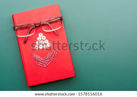 Children's fantasy joke. The imaginary face of a teacher from a book, glasses, paper clips and stationery buttons