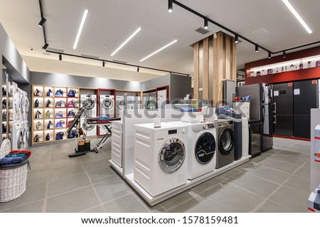 Washing machines and vacuum cleaners in the premium home appliance store Royalty-Free Stock Photo #1578159481