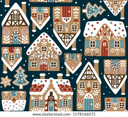 Seamless vector pattern with cute gingerbread houses and cookies on dark blue background. Perfect for textile, wallpaper or print design. Royalty-Free Stock Photo #1578166075