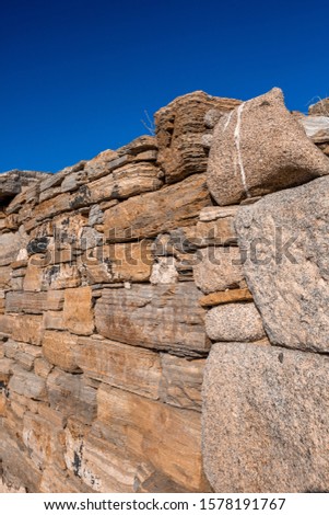 Closeup ancient stone wall of antique city with blue skies on the background