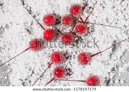 Toys and decor for Christmas tree. Cherry in the snow.