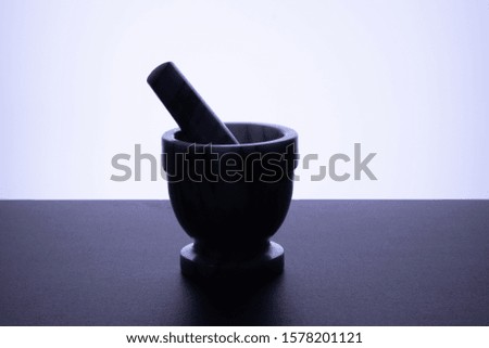 Manual bowl for grinding black pepper dark bottom white background