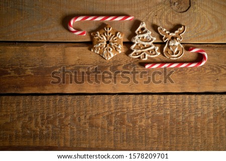 Ginger gingerbread and Christmas sweets on old wooden kitchen table