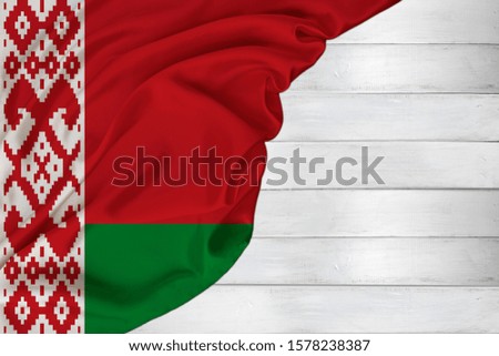horizontal colored national flag of the modern state of Belarus, beautiful silk, white wood background, concept of tourism, economy, politics, emigration, independence day, copy space, template