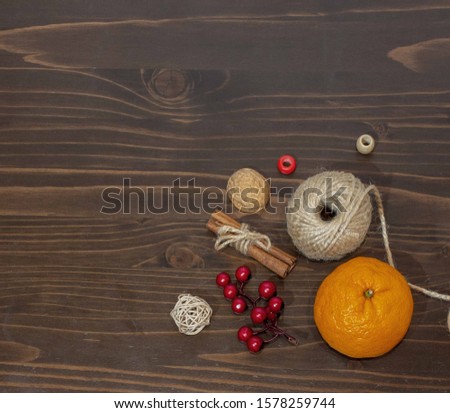 Christmas composition with tangerine, cinnamon, nuts on a dark background. Top view. Frame