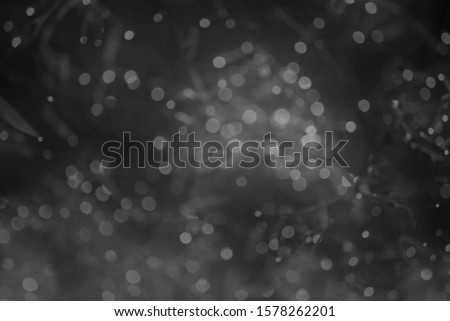 Abstract background white bokeh dispersion on a black background  