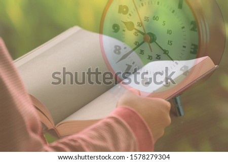 A double picture of a girl's hand opening a book to read On the background of an alarm clock