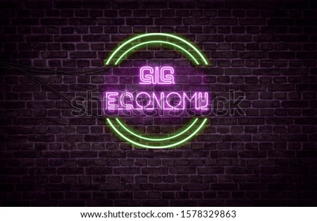 A green and purple neon light sign that reads:
Gig economy