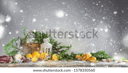 Christmas New Year composition with oranges, plaid, basket and green spruce on vintage wooden background. Russian tradition to decorate holidays with tangerines. Drawing snow