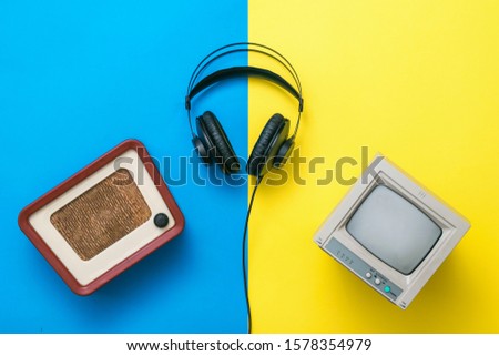 Vintage radios, headphones and TV on yellow and blue background. Set of ancient radio equipment.