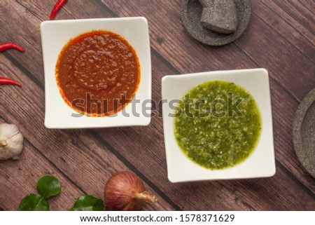 Flat lay of red and green chili paste. Asian food spicy paste with its fresh ingredient and delicacies. Scrumptious Asian food. Spicy chili dipping.
