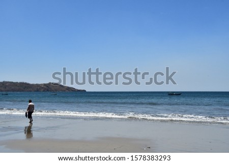 couple walking on the beach, photo as a background taken in Nicoya, Costa rica central america