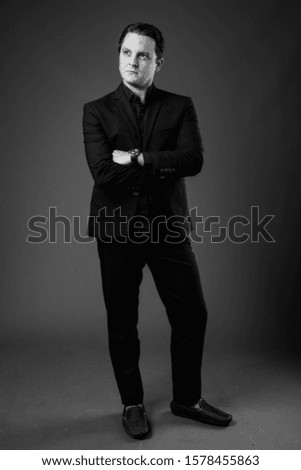 Studio shot of Italian businessman in black and white