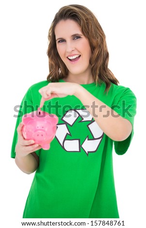 Environmental activist pointing at piggy bank against white background