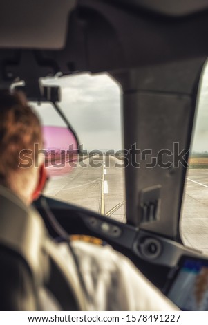 Inside cockpit of commercial airplane, Pilot approaching the landing runway.