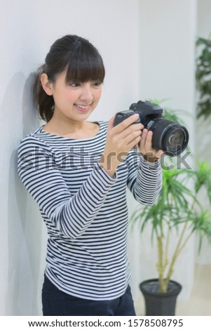 Woman checking photos with camera
