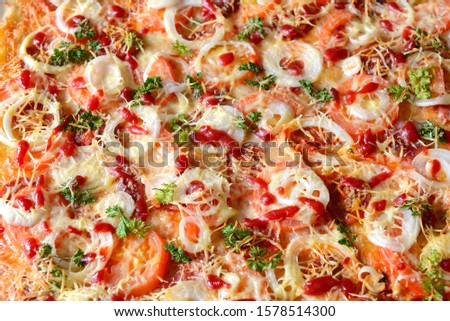ready pizza with cheese, tomatoes and onions. top view.