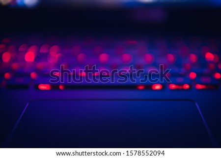blurred laptop. Blurred backlit laptop keyboard.