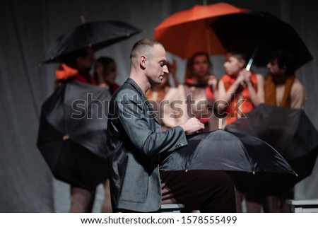 Actors and actresses play a modern lyrical performance of the show on the stage of the theater