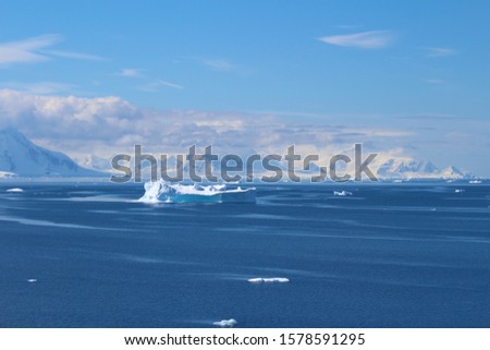 Icebergs and mountains of the Antarctic Peninsula. The mountains in the Gerlache Strait in the Danco Coast, Antarctica
