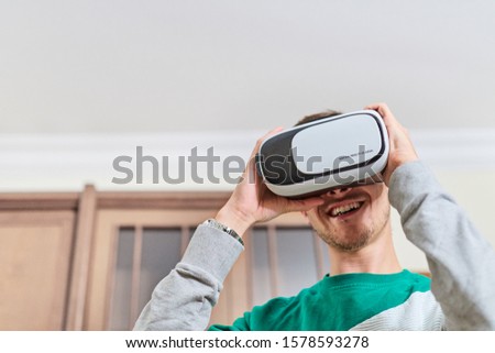 boy trying virtual reality glasses for the first time, he's having fun