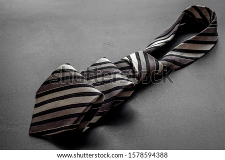 Father's day concept. Men's tie on black background copy space