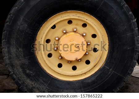 Bolts in orange wheel hub of truck wheel