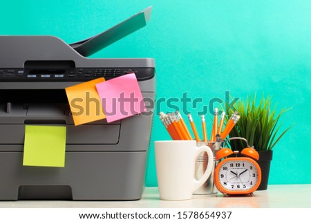 Printer, copier, scanner on color background . Office table