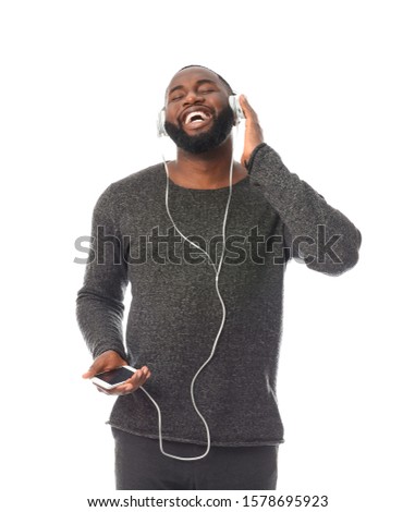 African-American man listening to music on white background