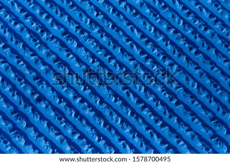 blue volumetric uneven stone plaster covering parallel wall lines, close-up, background, clean, pattern Royalty-Free Stock Photo #1578700495