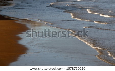 Composition of waves and sand on the beach high quality image perfect fro background or wallpaper