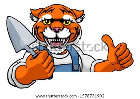 A tiger bricklayer builder construction worker mascot cartoon character holding a trowel tool and peeking around a sign and giving a thumbs up