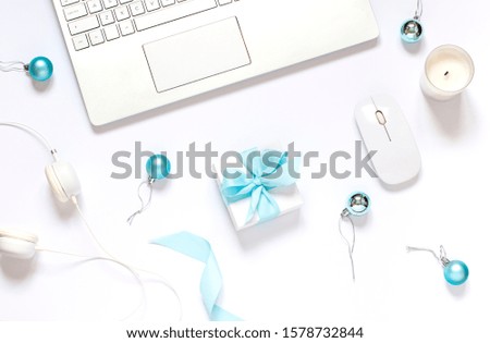 Christmas or New Year concept business flat lay with festive decorations, a gift and a keyboard on the white background. Top view . 