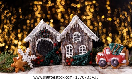 Christmas gingerbread, car, house. Light bulbs on the background.