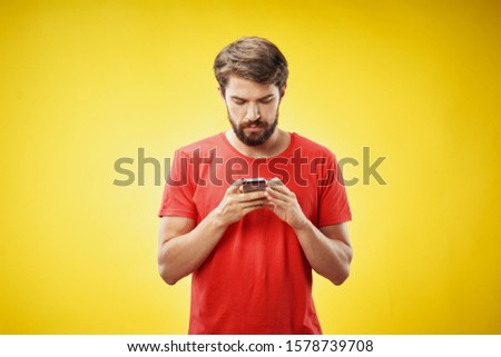 man in red t-shirt mobile phone isolated background