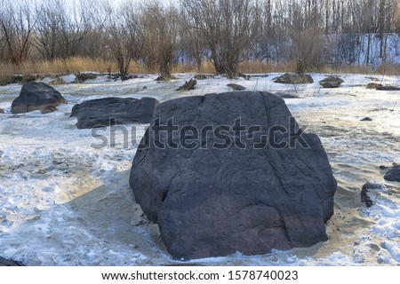 Sikachi-Alyan petroglyphs. Antique figure of sun horse carved in basalt stone on the Amur river bank. Оne of the seven wonders of the Khabarovsk territory. Far Est, Russia.