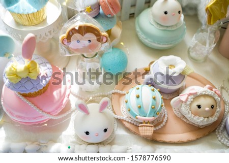 Dessert table for a party. Ombre cake, cupcakes, sweetness ,animal theme - Image