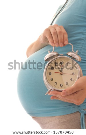 A pregnant woman with a clock on a white background