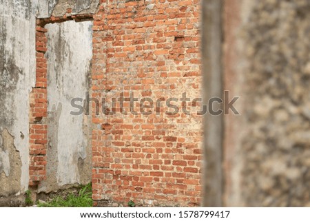 Perspective from the inside of a medieval fortress. A red and ruined wall of bricks